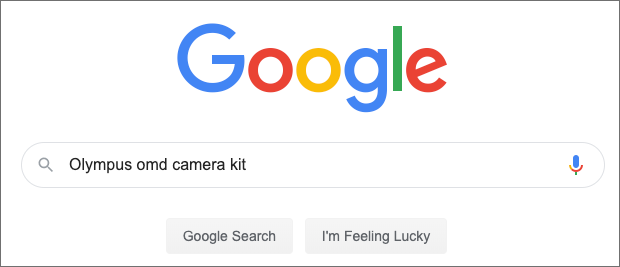 A screenshot of the Google search page with the term "olympus omd camera kit"